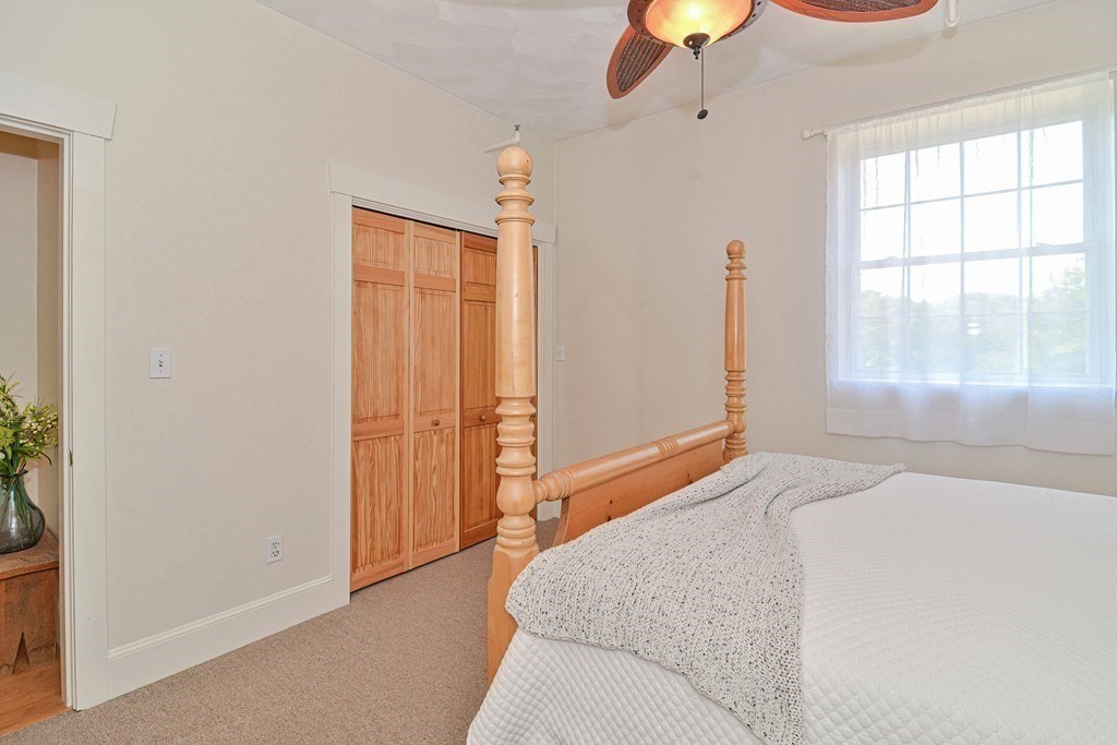 200 Cato Street, Unit 7 Woonsocket, RI 02895 - Photo 33 of 39 a bedroom with a bed and a chandelier