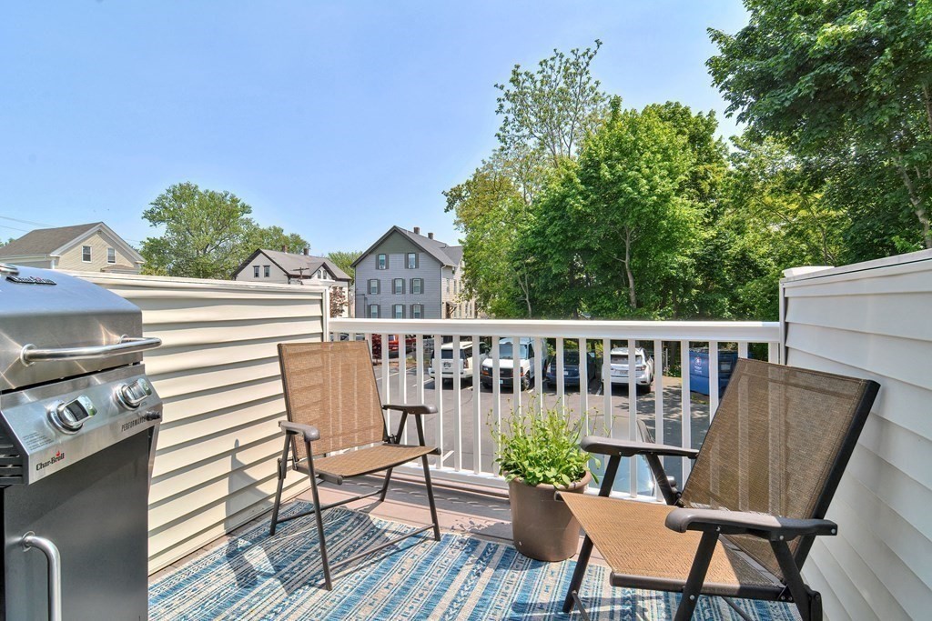 200 Cato Street, Unit 7 Woonsocket, RI 02895 - Photo 34 of 39 a view of a chairs and table on the deck