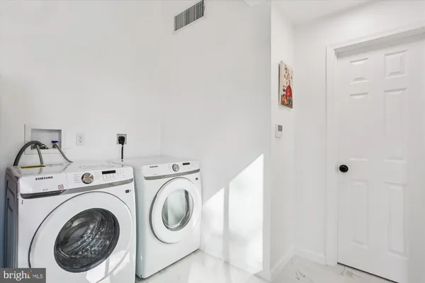 a view of an empty room with wooden floor and closet