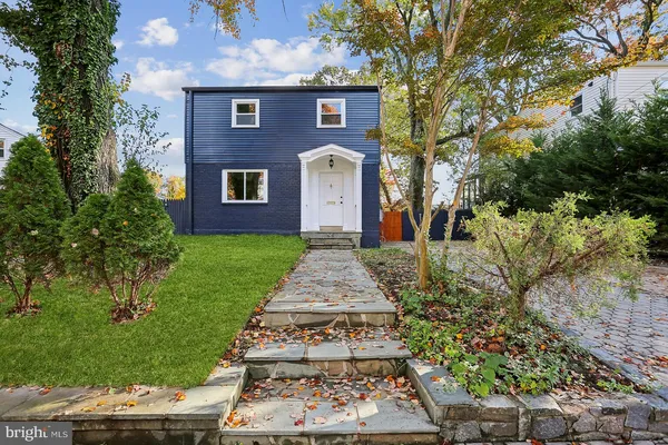 a view of a house with a yard and wooden fence