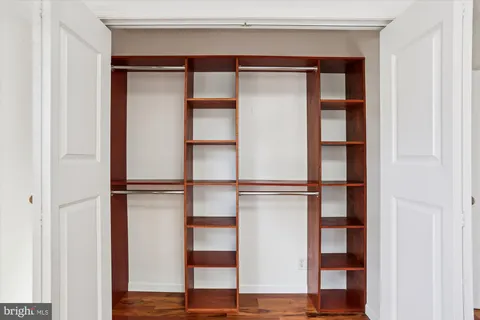 a view of a room with wooden floor and white walls