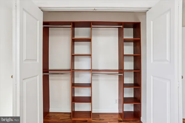 a view of a room with wooden floor and white walls