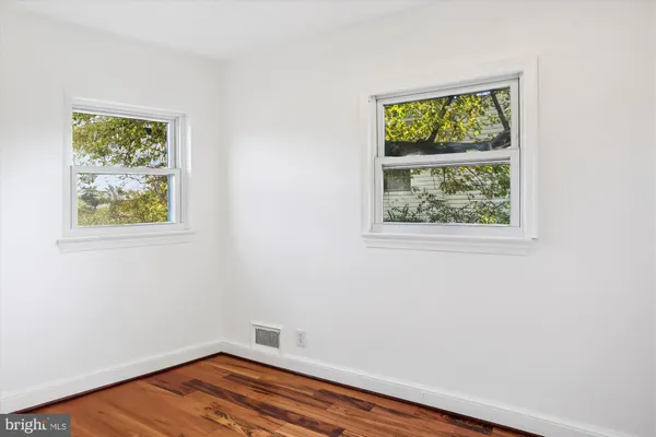 an empty room with wooden floor