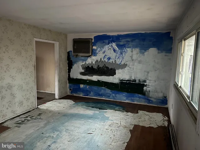 a room with water heater and wooden floor