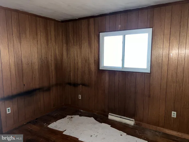 a room with a wooden floor and window