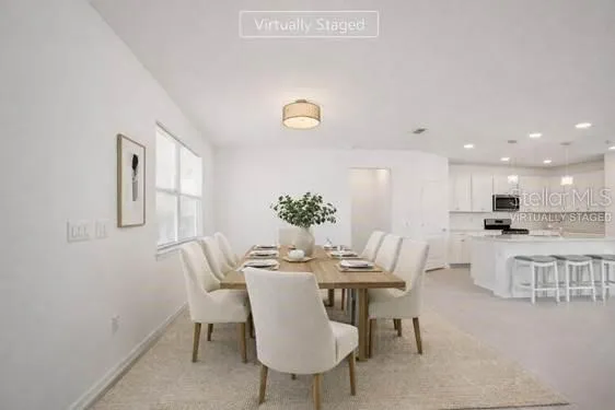 a kitchen with kitchen island white cabinets and stainless steel appliances