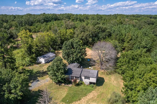 a aerial view of a house with a yard and garden