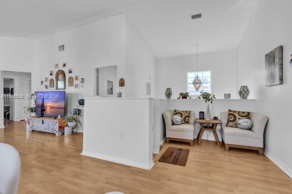 14817 Balgowan Road, Unit 2015 Miami Lakes, FL 33016 - Photo 14 of 39 a living room with furniture and a dining table with wooden floor