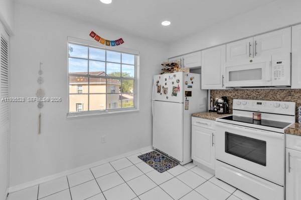 14817 Balgowan Road, Unit 2015 Miami Lakes, FL 33016 - Photo 18 of 39 a kitchen with appliances cabinets and a stove top oven