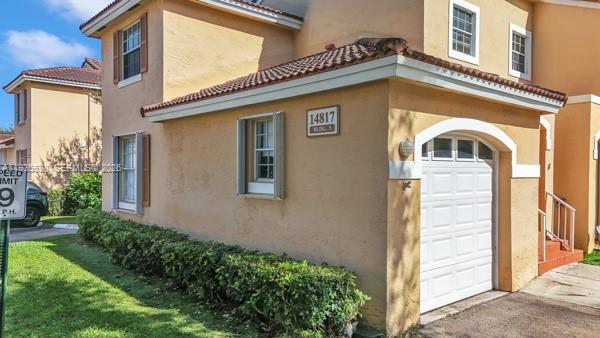 14817 Balgowan Road, Unit 2015 Miami Lakes, FL 33016 - Photo 26 of 39 a front view of a house with a yard