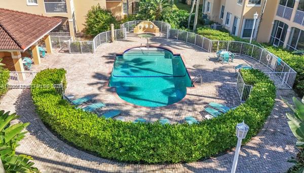 14817 Balgowan Road, Unit 2015 Miami Lakes, FL 33016 - Photo 34 of 39 a backyard of a house with a garden and outdoor seating
