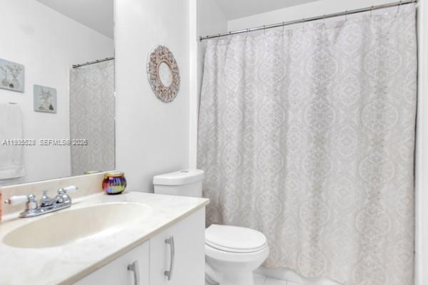 14817 Balgowan Road, Unit 2015 Miami Lakes, FL 33016 - Photo 10 of 39 a bathroom with a sink vanity mirror and toilet