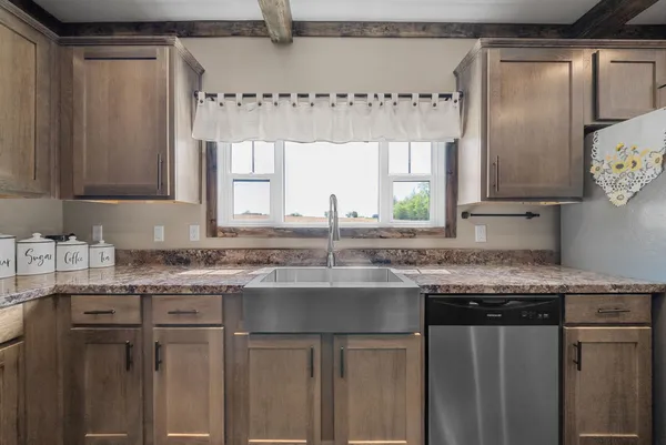 a kitchen with stainless steel appliances granite countertop a sink and a granite counter tops