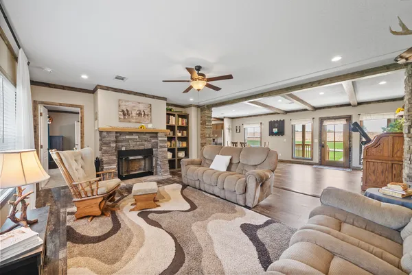 a living room with furniture a fireplace and a chandelier