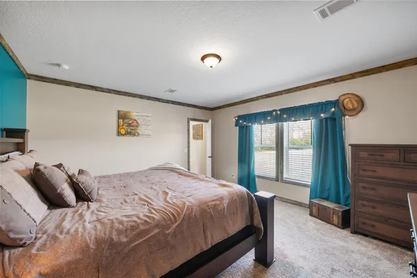 a bedroom with a large bed and a window