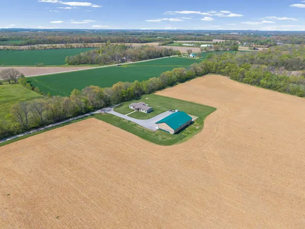 an aerial view of a house with a yard