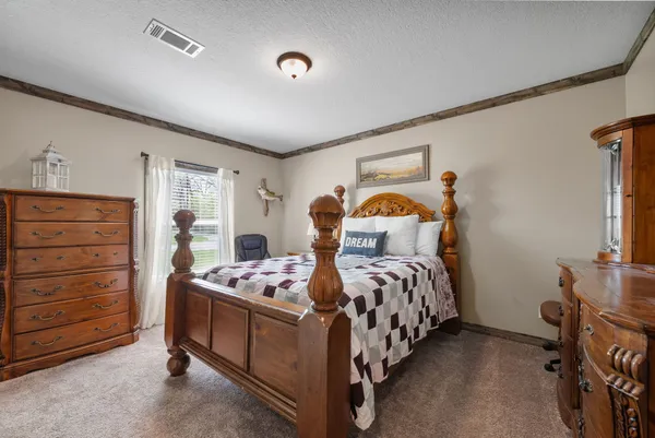 a bedroom with a bed and a tv