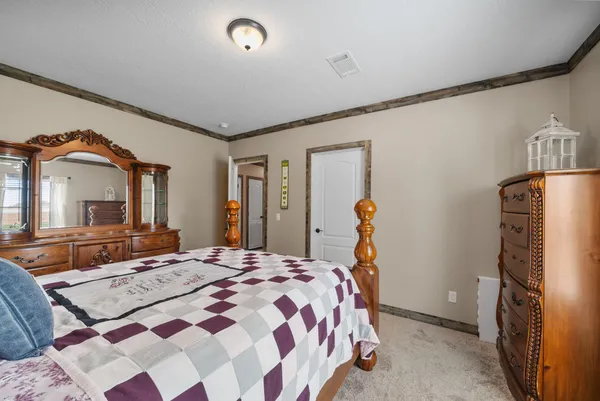 a bedroom with a bed and a mirror