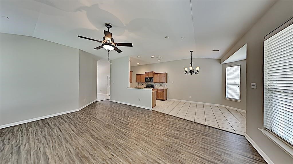 21338 Bella Flora Court Spring, TX 77379 - Photo 2 of 10 a view of a kitchen with wooden floor and windows