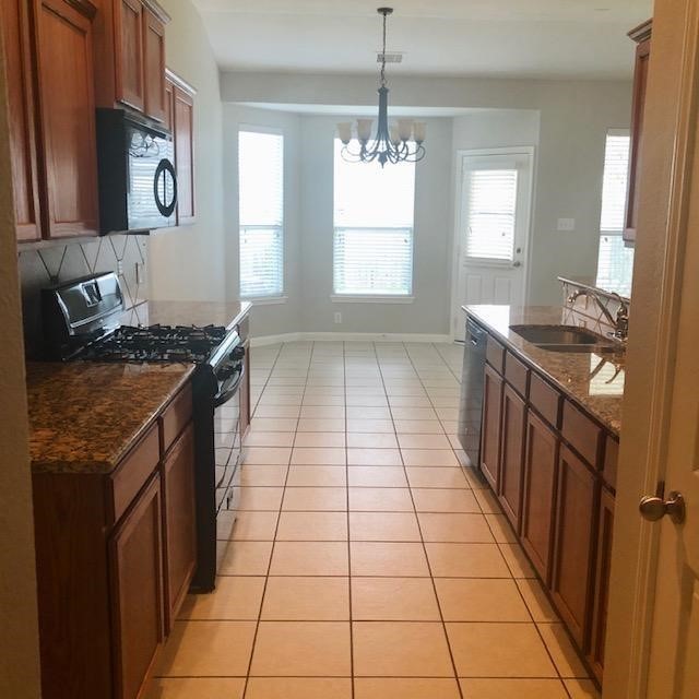 21338 Bella Flora Court Spring, TX 77379 - Photo 6 of 10 a kitchen with a stove top oven sink and window