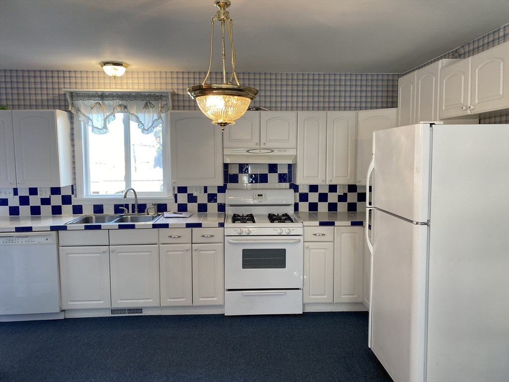 10 Frederic Street Springfield, MA 01119 - Photo 6 of 26 a kitchen with stainless steel appliances a white refrigerator a sink a stove a microwave and cabinets