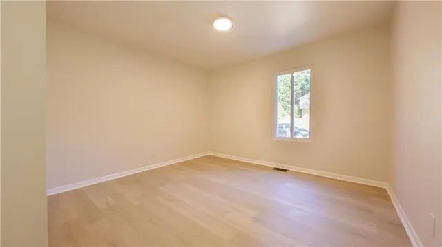an empty room with a empty space and a window