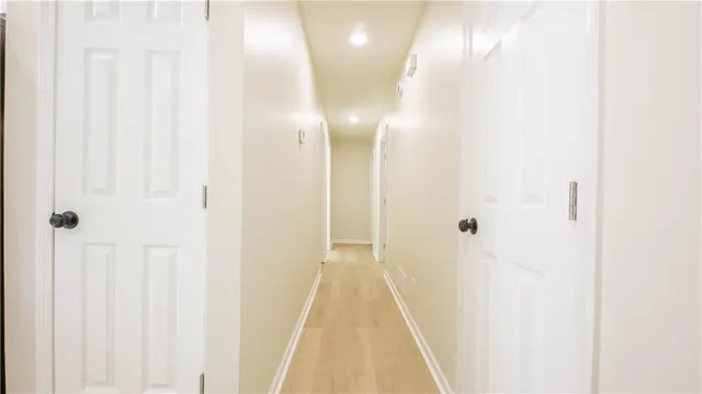 a view of a hallway with wooden floor