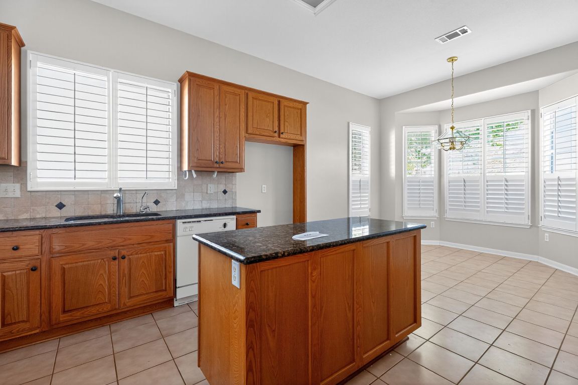 130 Crepe Myrtle Lane Georgetown, TX 78633 - Photo 11 of 33 a kitchen with stainless steel appliances granite countertop a sink stove and cabinets