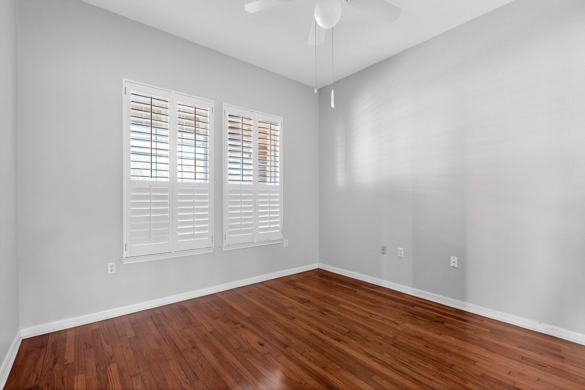 130 Crepe Myrtle Lane Georgetown, TX 78633 - Photo 13 of 33 an empty room with wooden floor and windows