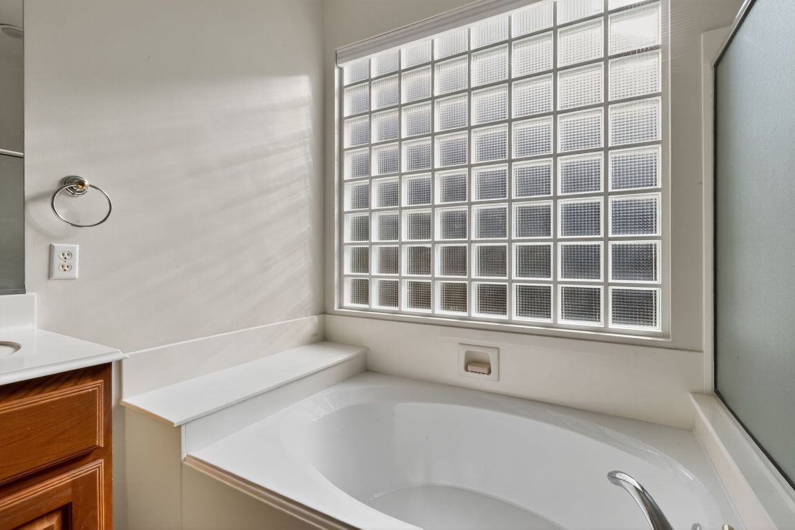 130 Crepe Myrtle Lane Georgetown, TX 78633 - Photo 19 of 33 a bathroom with a bathtub and next to a window