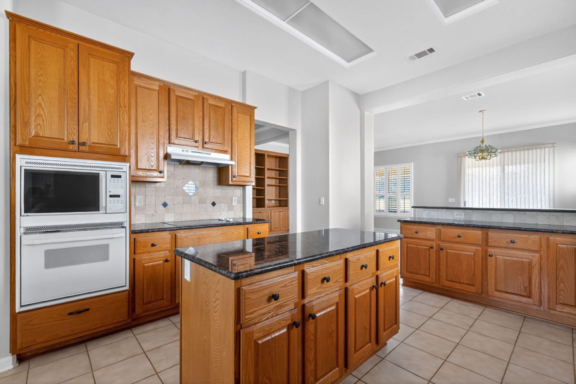 130 Crepe Myrtle Lane Georgetown, TX 78633 - Photo 4 of 33 a kitchen with stainless steel appliances granite countertop a sink and cabinets