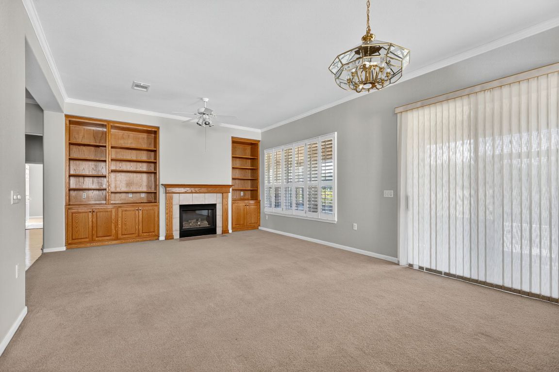 130 Crepe Myrtle Lane Georgetown, TX 78633 - Photo 8 of 33 an empty room with furniture and fireplace