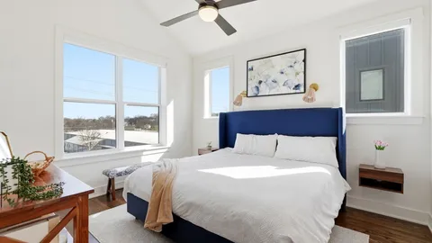 a bedroom with a large bed and a window