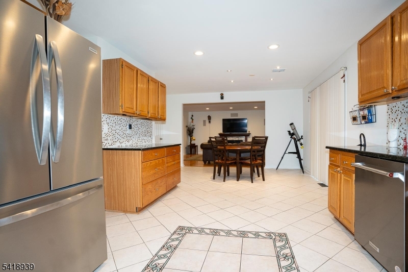 54 Campbell Road Hillsborough, NJ 08844 - Photo 11 of 31 a kitchen with stainless steel appliances kitchen island granite countertop a refrigerator and a stove top oven
