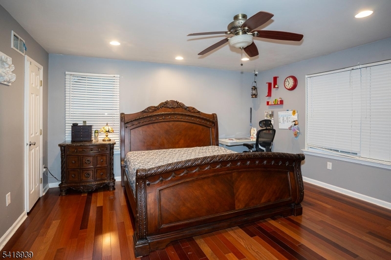 54 Campbell Road Hillsborough, NJ 08844 - Photo 16 of 31 a bedroom with a bed and a chandelier