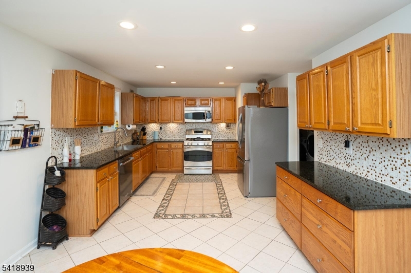 54 Campbell Road Hillsborough, NJ 08844 - Photo 9 of 31 a large kitchen with stainless steel appliances granite countertop a stove refrigerator and a sink
