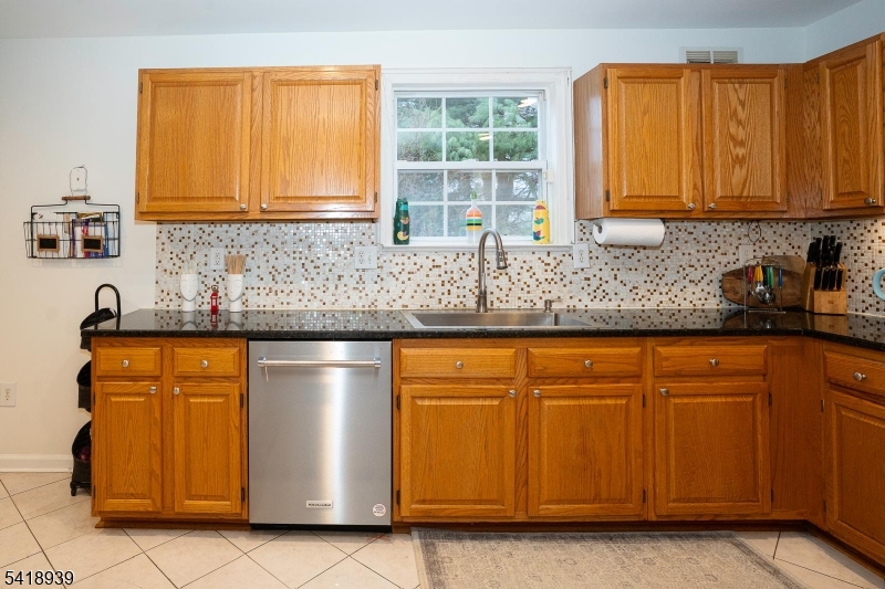 54 Campbell Road Hillsborough, NJ 08844 - Photo 10 of 31 a kitchen with stainless steel appliances granite countertop wooden cabinets a sink a stove a refrigerator with grey cabinets