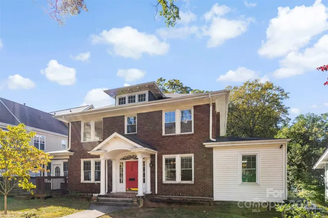 a front view of residential houses with yard
