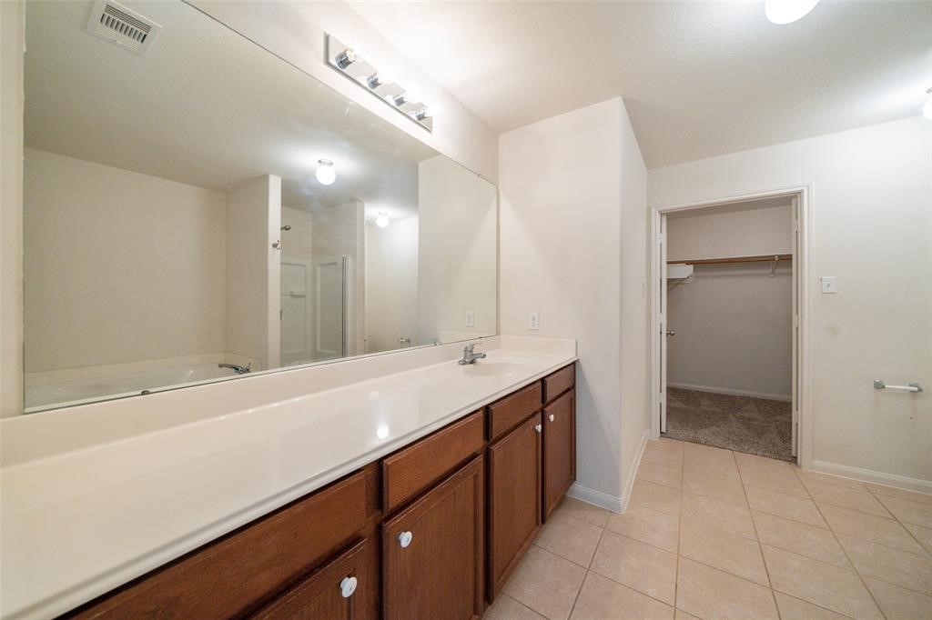 9926 Opal Rock Drive Rosharon, TX 77583 - Photo 6 of 8 a spacious bathroom with a shower sink and mirror