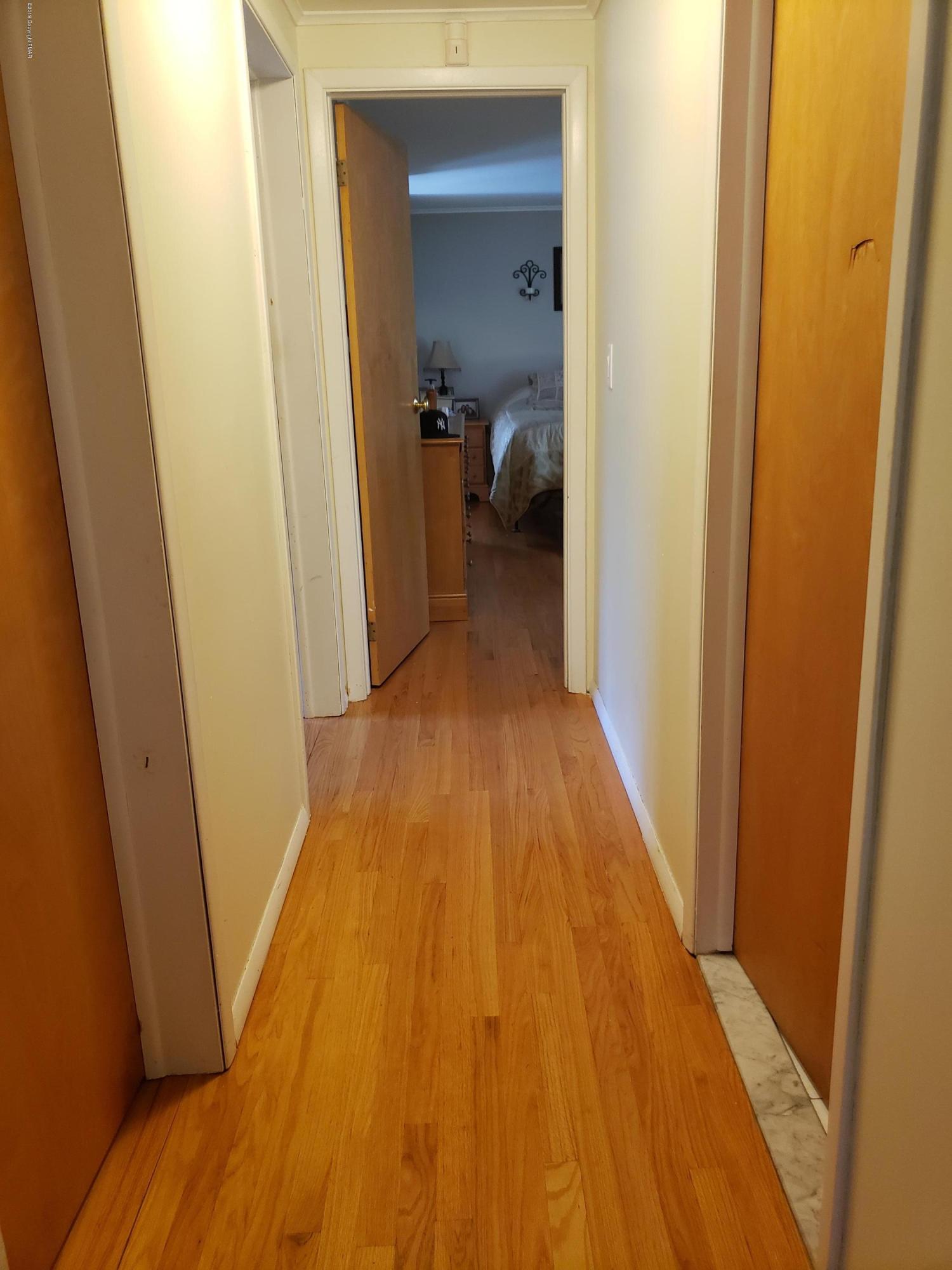 4307 Pine Ridge Drive West Bushkill, PA 18324 - Photo 18 of 28 a view of a hallway with wooden floor and a bedroom
