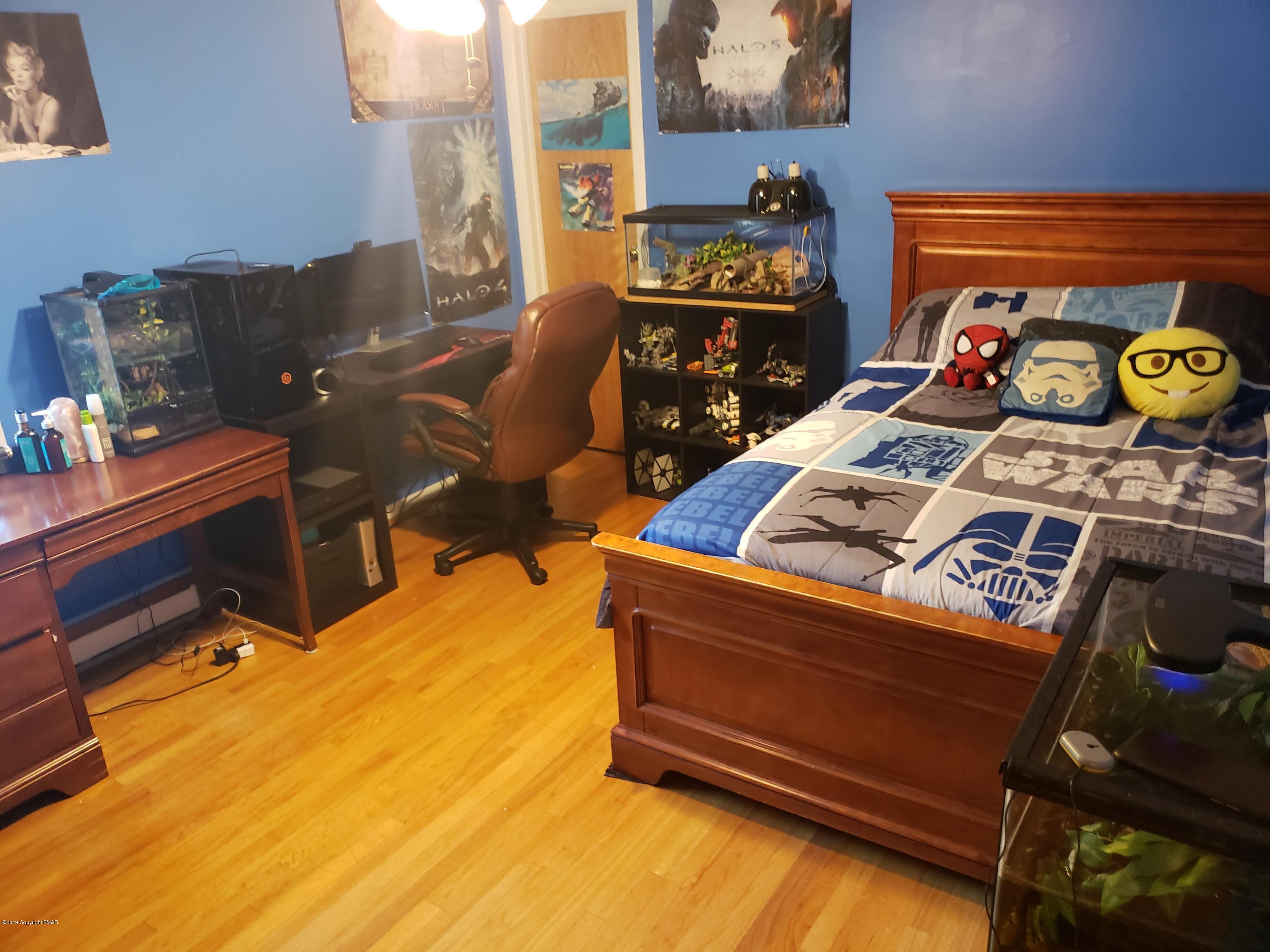 4307 Pine Ridge Drive West Bushkill, PA 18324 - Photo 20 of 28 a bed room with a bed and a tv