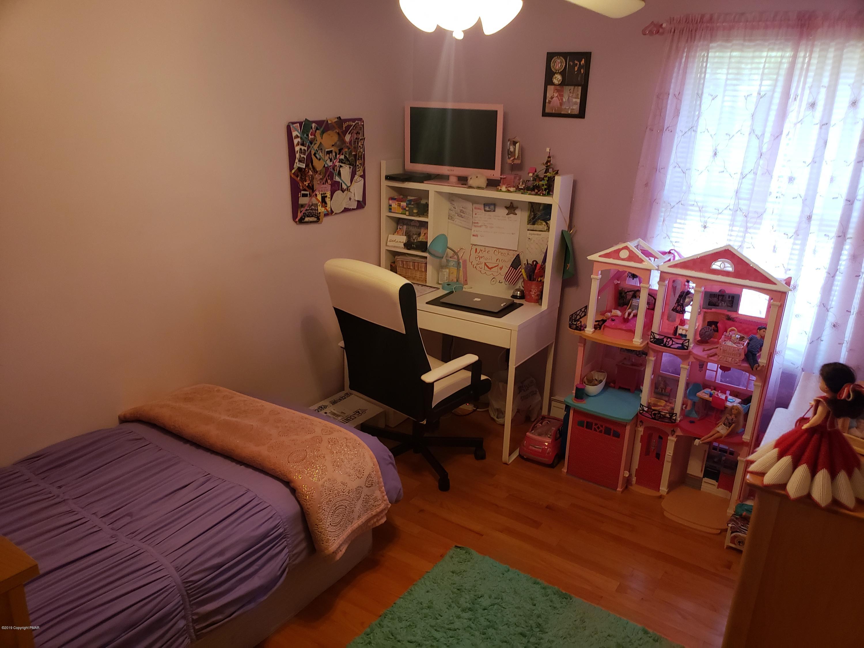 4307 Pine Ridge Drive West Bushkill, PA 18324 - Photo 23 of 28 a bedroom with a bed and a tv