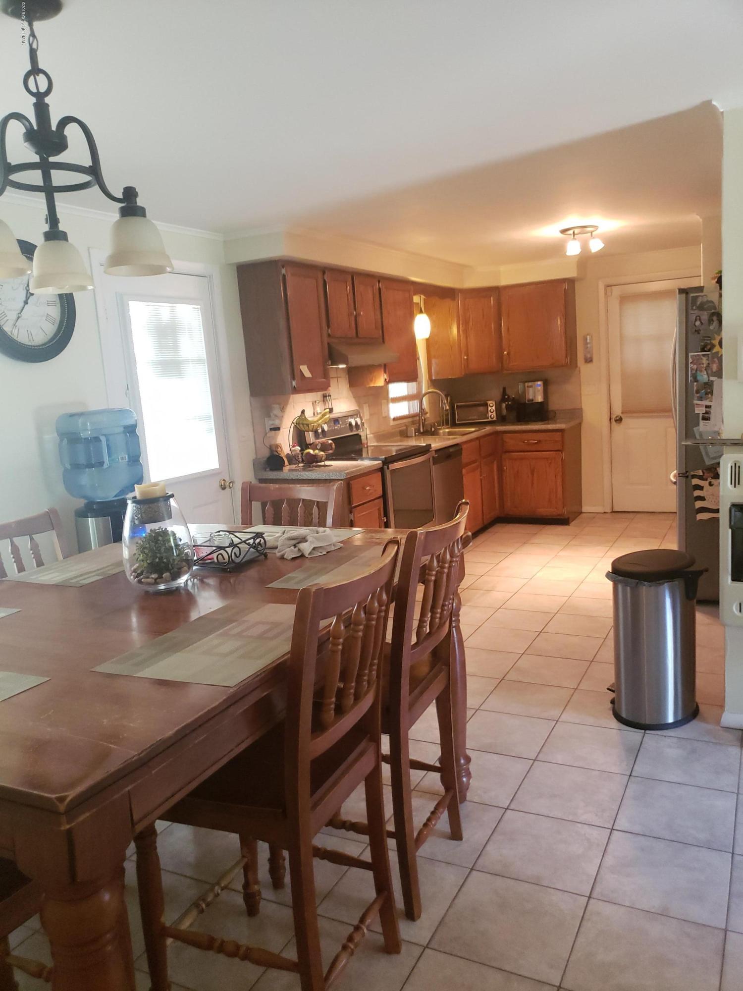 4307 Pine Ridge Drive West Bushkill, PA 18324 - Photo 7 of 28 a kitchen with a dining table chairs and stove
