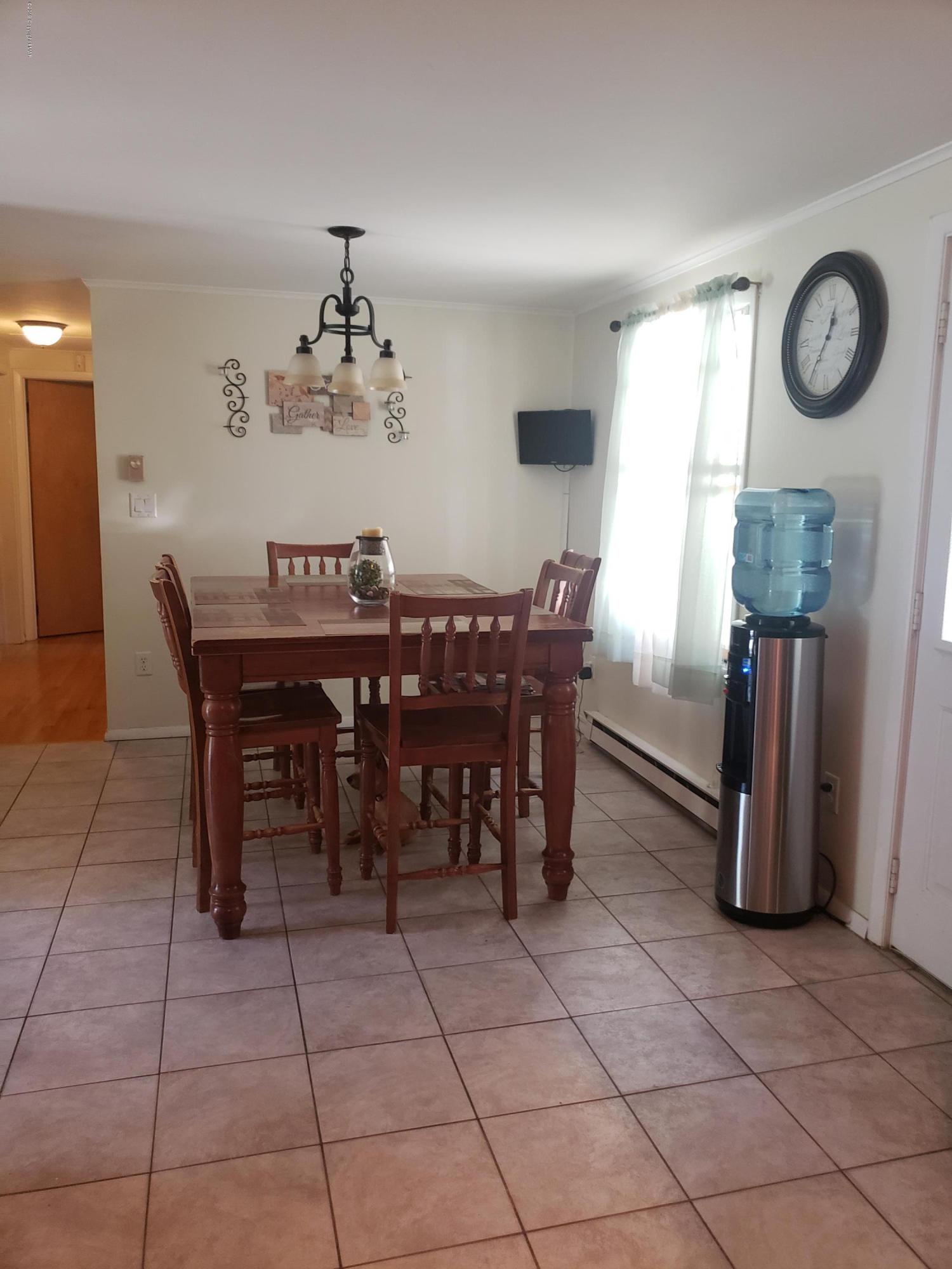 4307 Pine Ridge Drive West Bushkill, PA 18324 - Photo 10 of 28 a view of a dining room with furniture and a chandelier