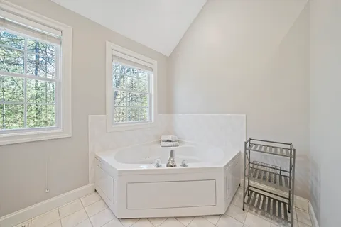 a bathroom with a bathtub and window