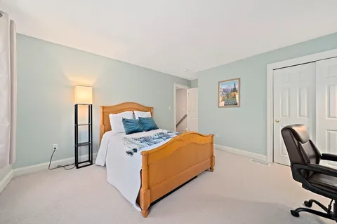 a bed room with a bed and a chair