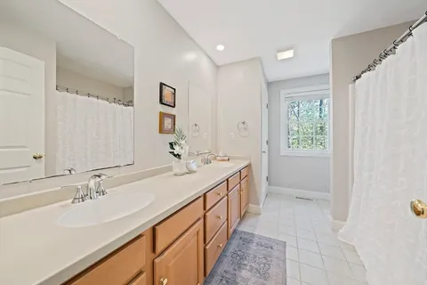 a bathroom with a double vanity sink a and a mirror