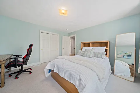 a bedroom with a bed and a desk