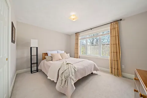 a bed room with a bed and a window