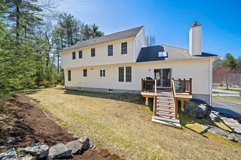 a view of a house with backyard and sitting area